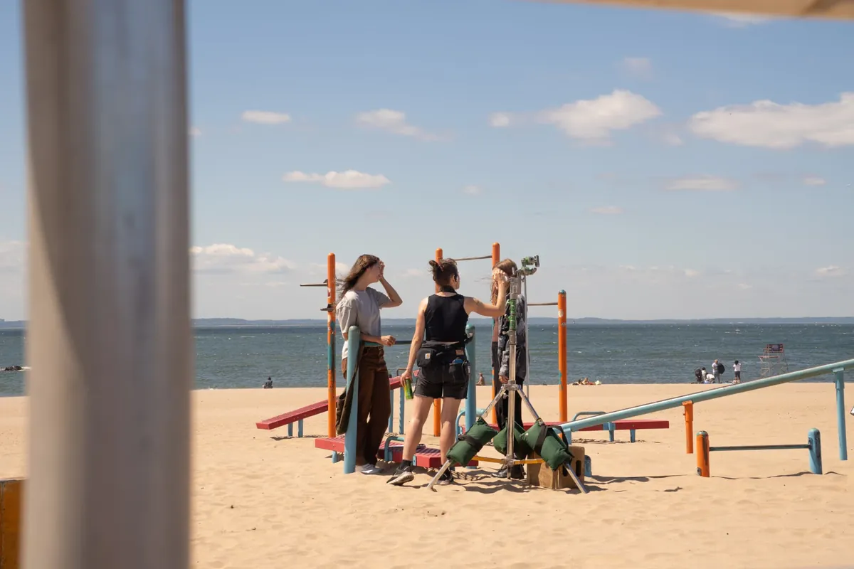 Behind the scenes — hair and makeup touch-ups on the beach set