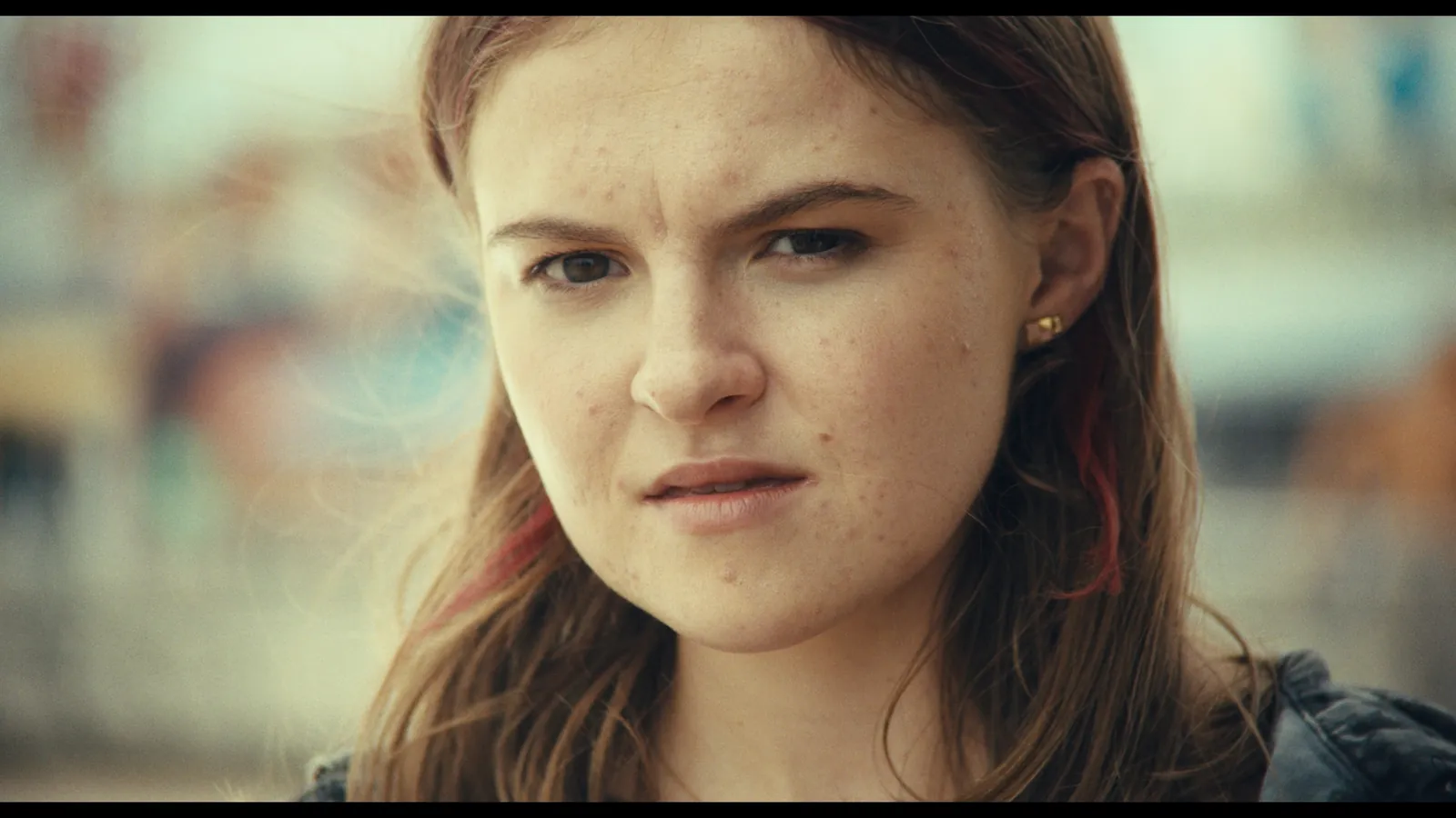 Perfect Love still — close-up of a young woman with a determined gaze